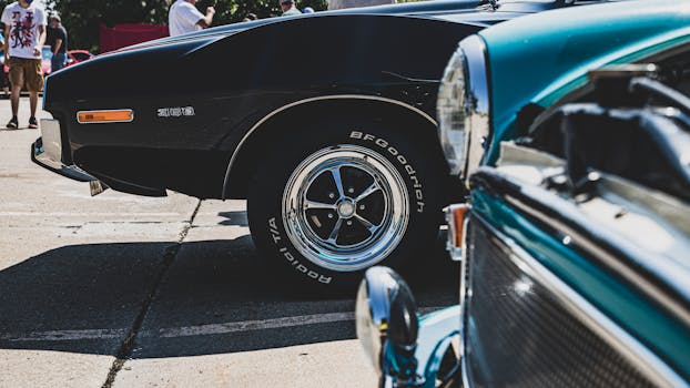 A classic Ford Mustang next to its electric counterpart